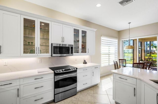 kitchen featuring visible vents, appliances with stainless steel finishes, white cabinets, and light countertops