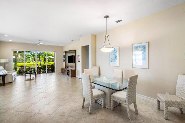 dining room featuring light tile patterned flooring, visible vents, ceiling fan, and baseboards