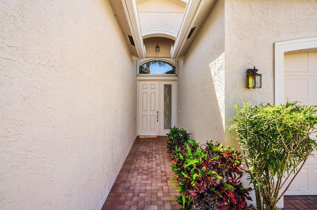 property entrance with stucco siding