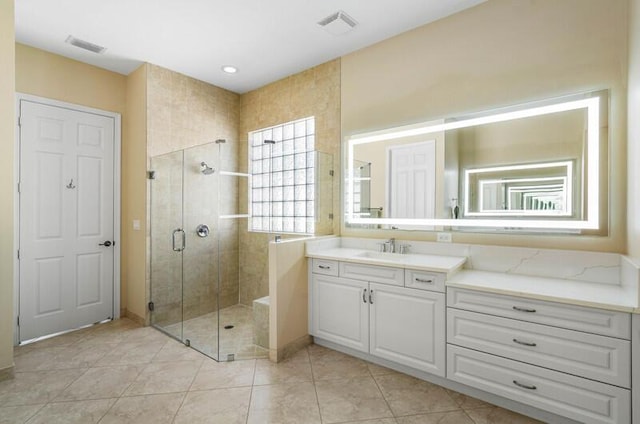 full bathroom featuring tile patterned floors, visible vents, a stall shower, and vanity