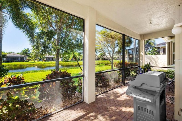 sunroom / solarium with a water view