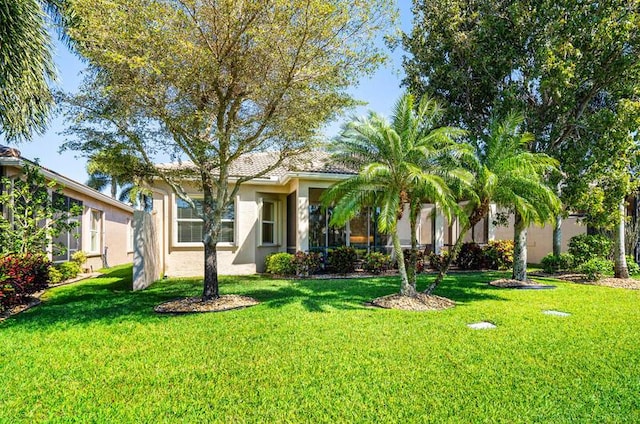 view of front facade with a front lawn and stucco siding