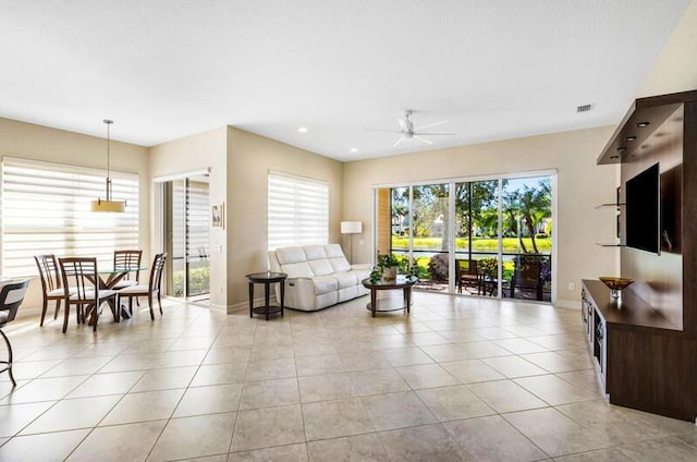 living area with visible vents, ceiling fan, baseboards, light tile patterned floors, and recessed lighting