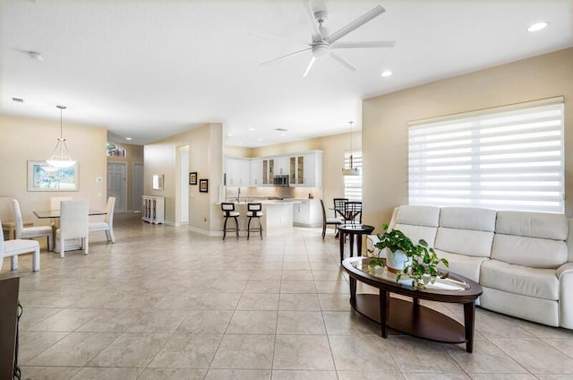 living area featuring recessed lighting, baseboards, a ceiling fan, and light tile patterned floors