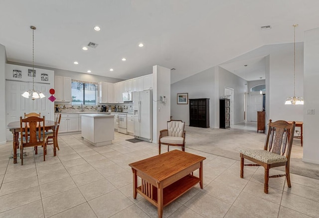 living area with visible vents, recessed lighting, vaulted ceiling, a chandelier, and light tile patterned floors