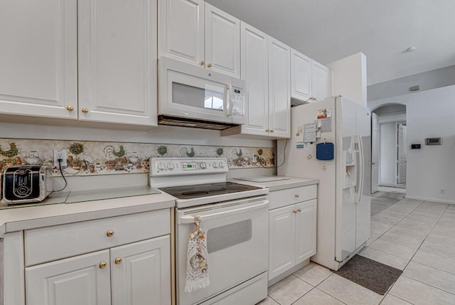 kitchen featuring white cabinetry, white appliances, and arched walkways