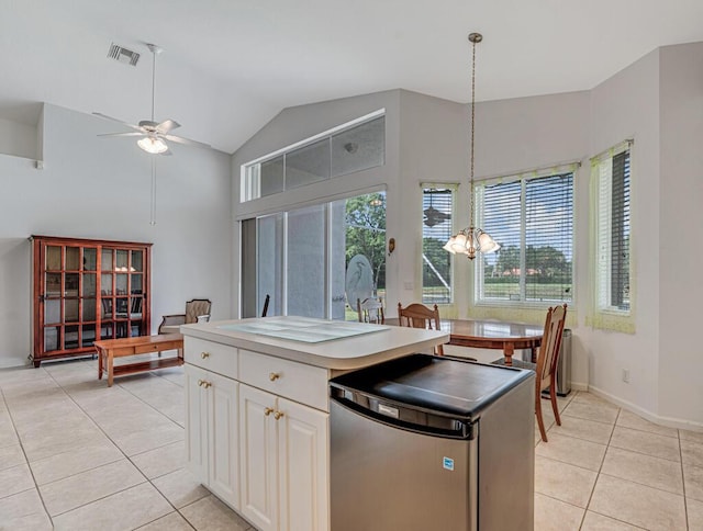 kitchen featuring ceiling fan with notable chandelier, refrigerator, pendant lighting, visible vents, and light tile patterned flooring