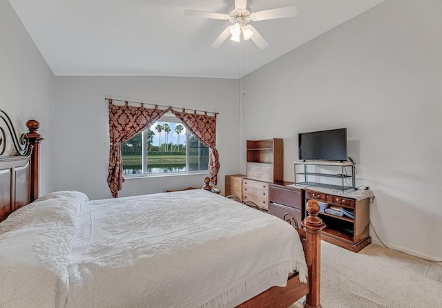 bedroom with vaulted ceiling, light colored carpet, baseboards, and ceiling fan