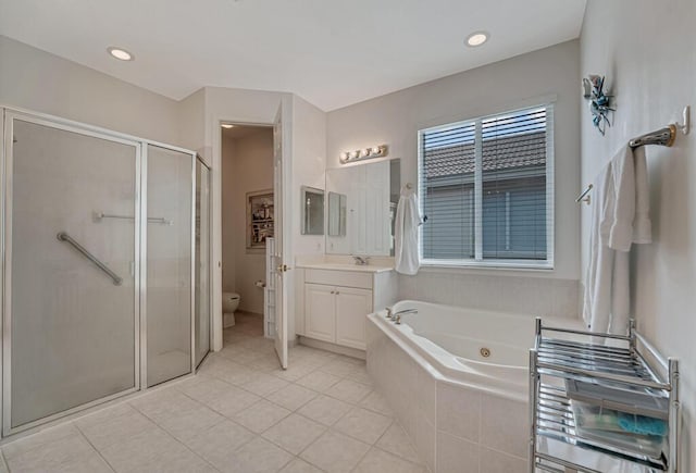 bathroom with a tub with jets, toilet, a stall shower, and vanity