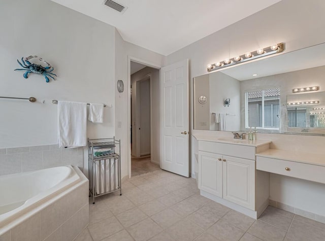 bathroom featuring tile patterned flooring, vanity, visible vents, and a bath