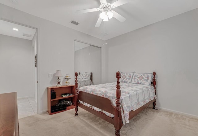 bedroom with carpet, a ceiling fan, a closet, visible vents, and baseboards