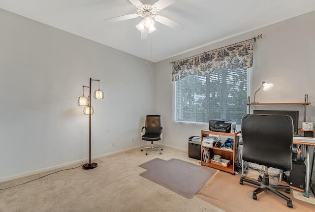 office area with a ceiling fan, baseboards, and carpet floors