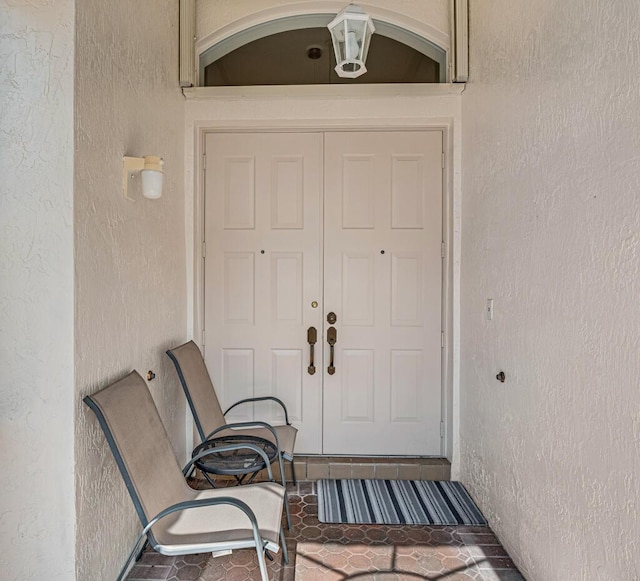 entrance to property featuring stucco siding