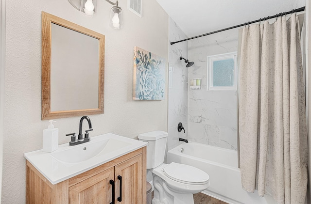 bathroom featuring toilet, wood finished floors, vanity, visible vents, and shower / bathtub combination with curtain