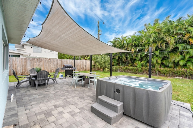 view of patio / terrace featuring a hot tub, a grill, outdoor dining area, and a fenced backyard