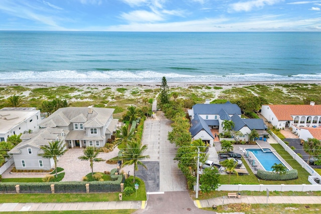 bird's eye view featuring a water view and a beach view