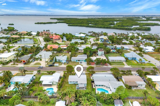 bird's eye view featuring a water view and a residential view