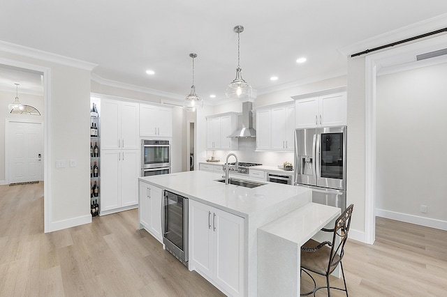 kitchen featuring beverage cooler, a center island with sink, stainless steel appliances, crown molding, and wall chimney range hood