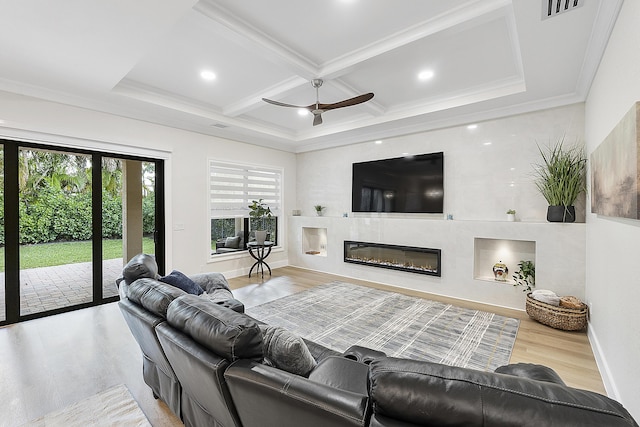 living area with baseboards, visible vents, coffered ceiling, ornamental molding, and a glass covered fireplace