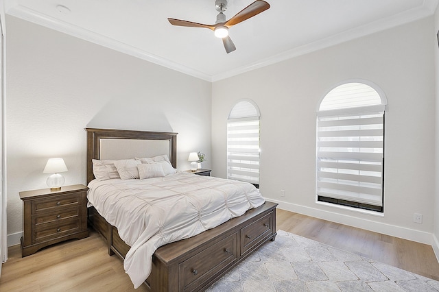 bedroom featuring baseboards, ornamental molding, a ceiling fan, and light wood finished floors