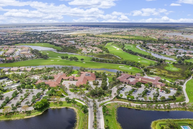 bird's eye view with golf course view, a water view, and a residential view