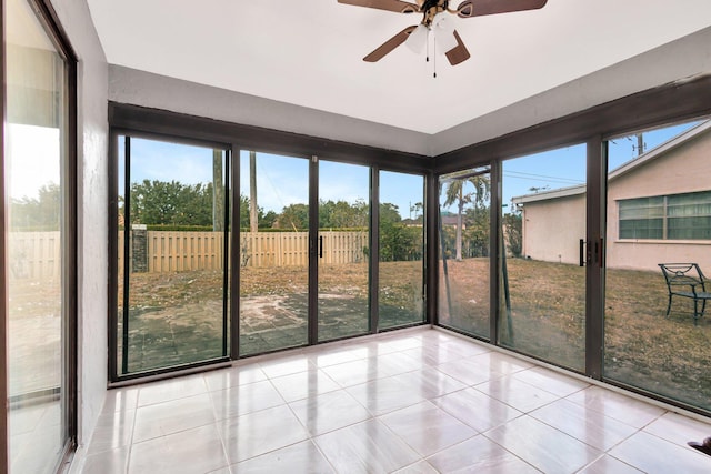 unfurnished sunroom featuring plenty of natural light and ceiling fan