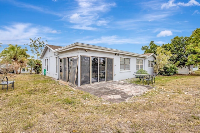 rear view of property with a patio and a yard