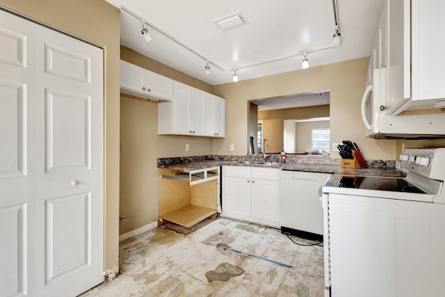 kitchen with visible vents, track lighting, a sink, white appliances, and white cabinets