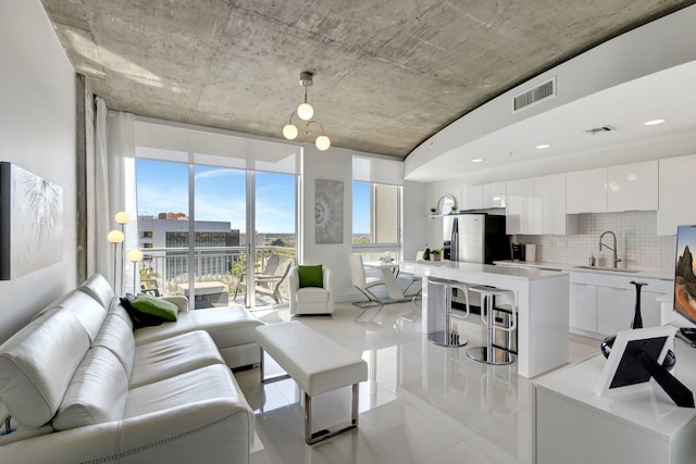 living area with light tile patterned flooring and visible vents