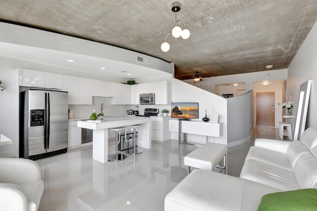 living area featuring a ceiling fan and visible vents