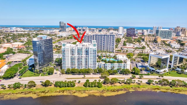 drone / aerial view featuring a view of city and a water view