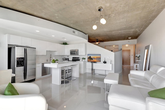 living area featuring visible vents and a ceiling fan