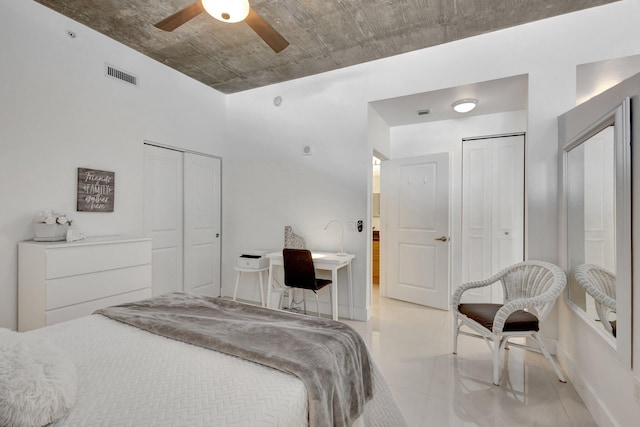 bedroom featuring visible vents, multiple closets, and ceiling fan