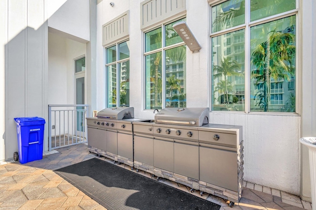 view of patio / terrace with exterior kitchen and a grill