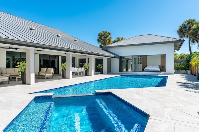 view of pool with ceiling fan, a patio area, and an outdoor hangout area