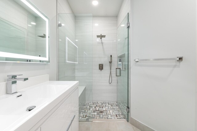 interior details featuring a marble finish shower