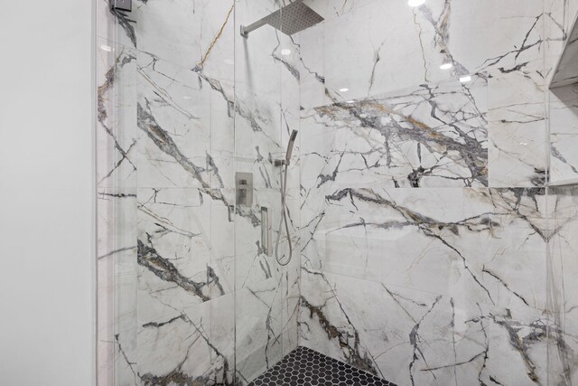 full bath featuring a marble finish shower, toilet, and vanity