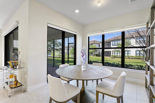 dining space with light tile patterned flooring, baseboards, and recessed lighting