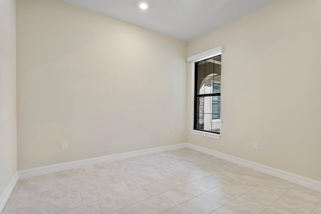 unfurnished room featuring baseboards and recessed lighting
