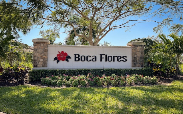 community sign featuring a lawn