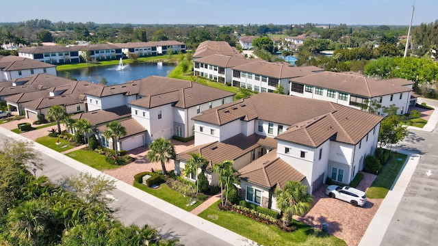 drone / aerial view with a water view and a residential view