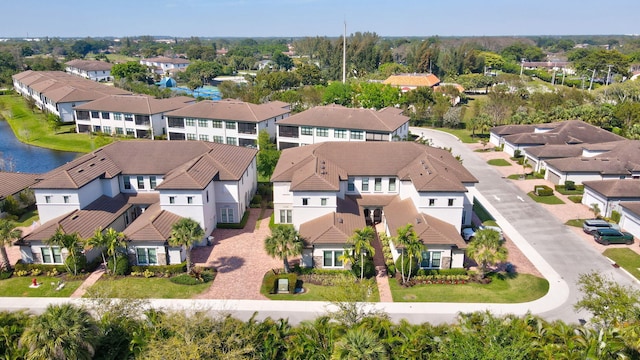 drone / aerial view featuring a residential view and a water view