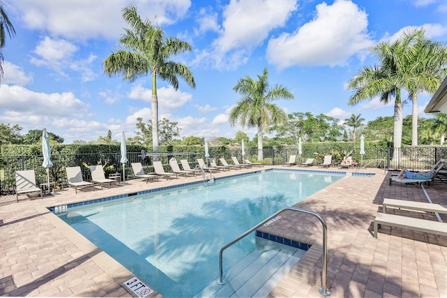 pool featuring fence and a patio