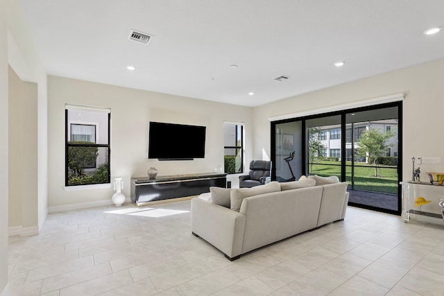 living area featuring baseboards, visible vents, recessed lighting, and light tile patterned floors