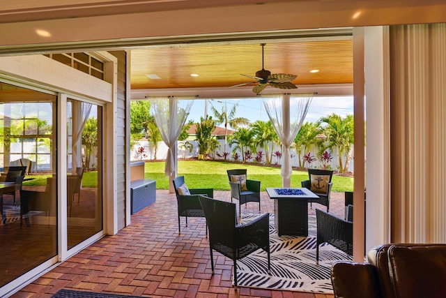 view of patio / terrace with an outdoor living space with a fire pit, a fenced backyard, and ceiling fan