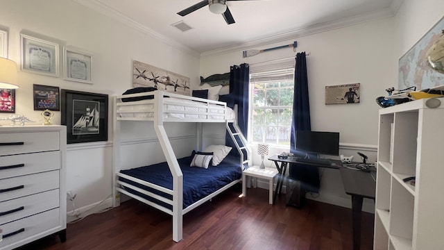 bedroom with visible vents, ornamental molding, ceiling fan, and wood finished floors