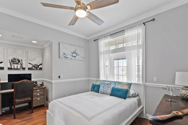 bedroom featuring baseboards, crown molding, a ceiling fan, and wood finished floors