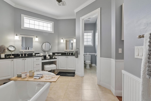 bathroom featuring a wainscoted wall, tile patterned flooring, visible vents, and a healthy amount of sunlight