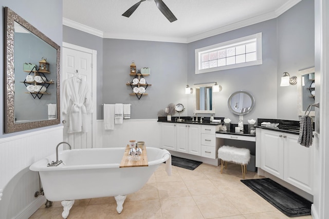 full bathroom with a freestanding tub, ornamental molding, and wainscoting