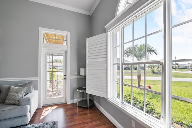 entryway with baseboards, crown molding, and wood finished floors